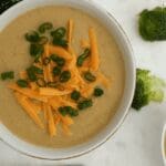 Broccoli cheese soup topped with shredded cheddar and green onions