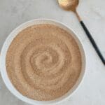Sourdough breadcrumbs shown with gold, decorative spoon
