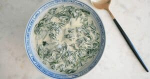 3-ingredient creamed spinach in bowl with decorative spoon