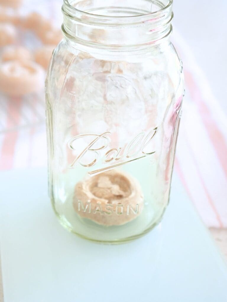 A frozen sourdough starter disc in a mason jar on top of a scale.