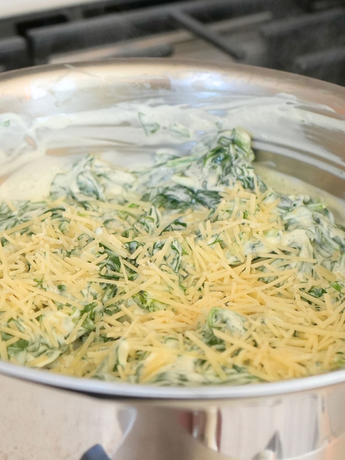 Parmesan cheese on top of creamed spinach.