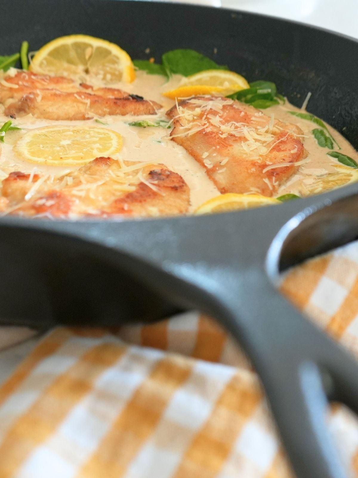 Creamy lemon chicken in a cast iron skillet.