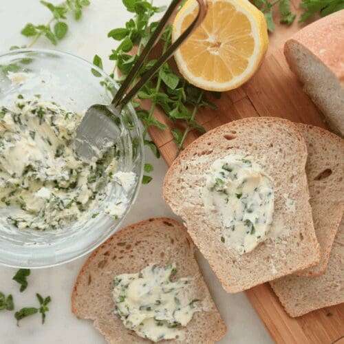 Homemade herb butter with slices of bread