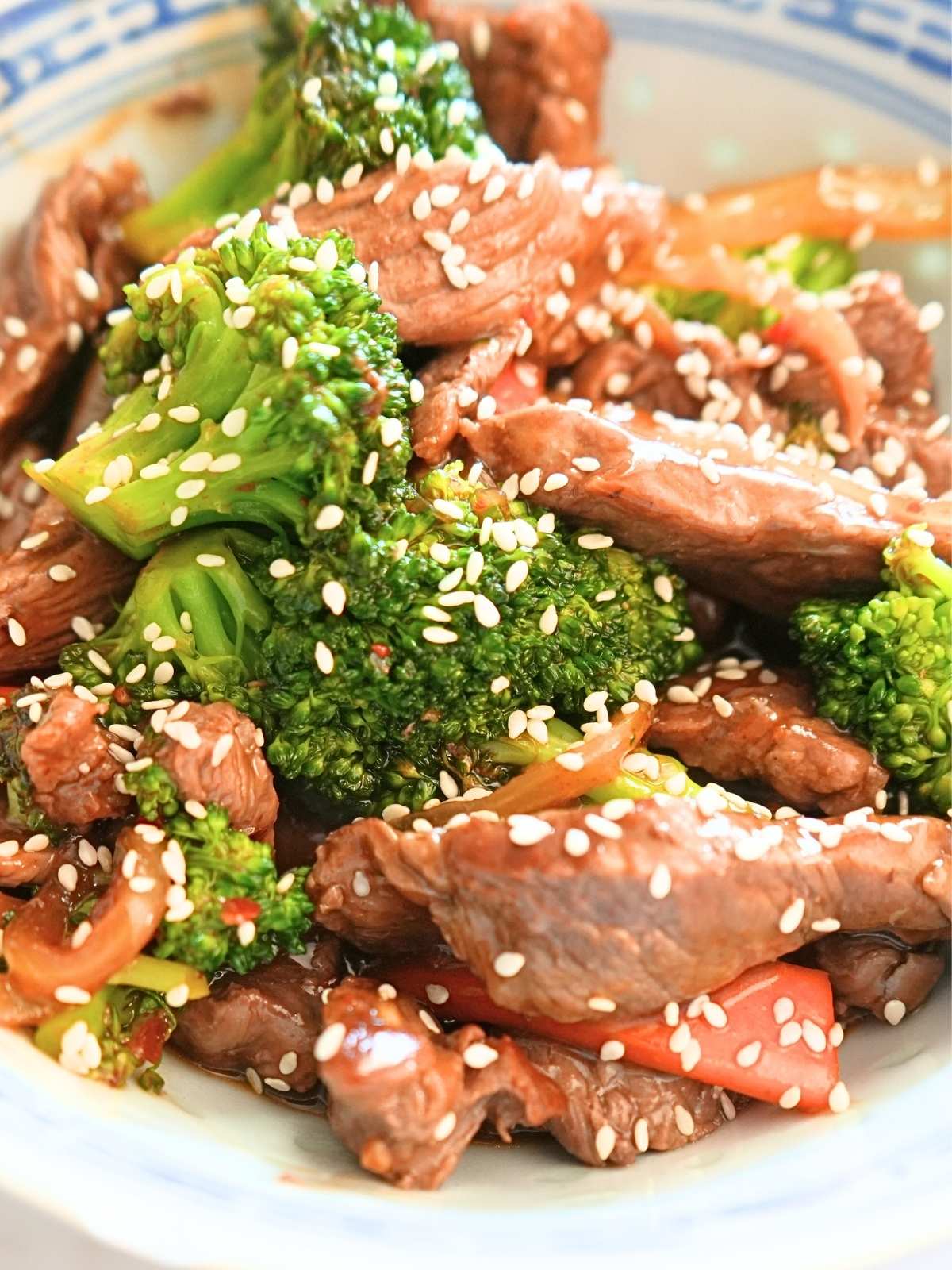 Cooked beef and broccoli freezer meal garnished with sesame seeds.