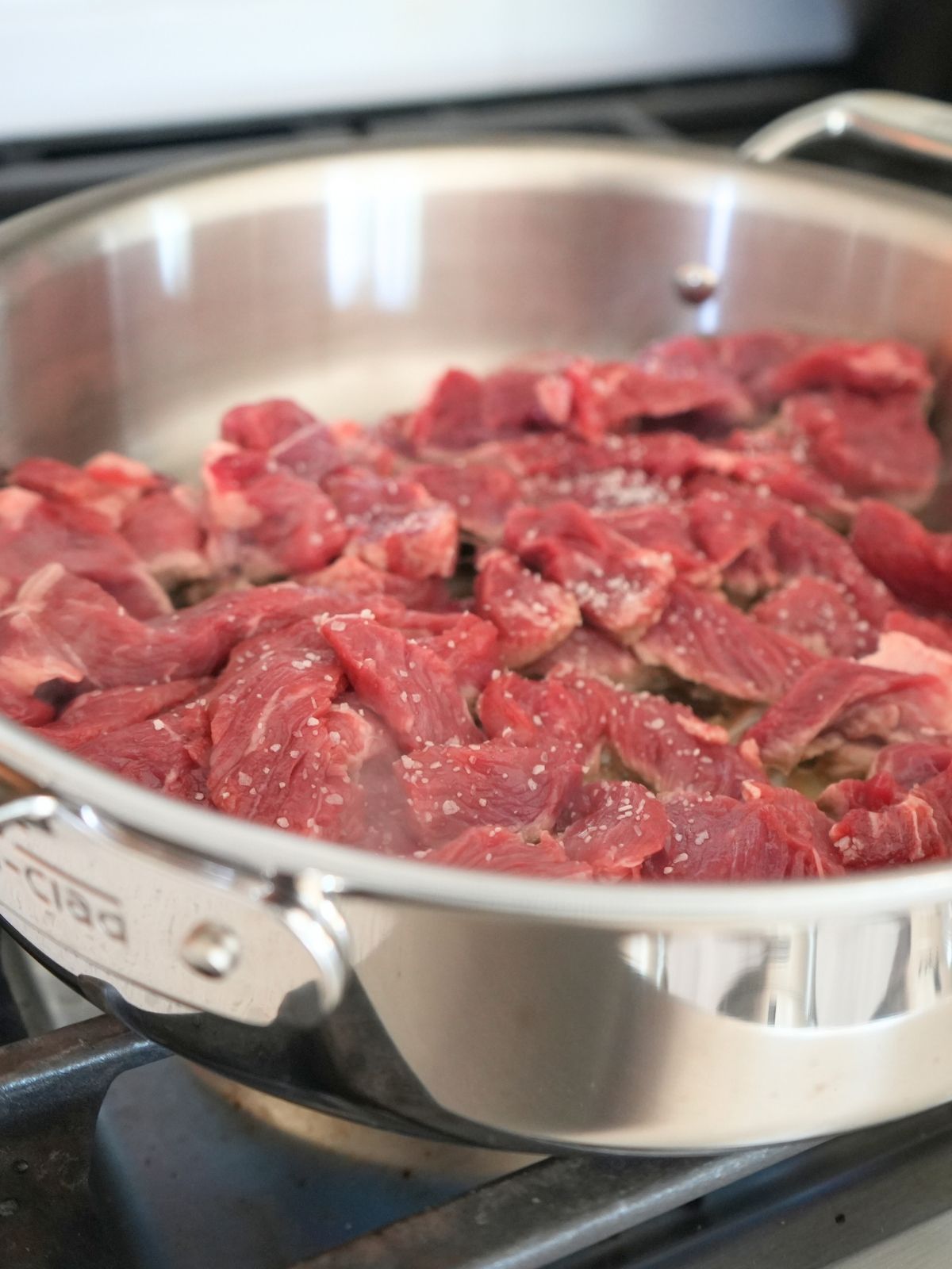 Steak cooking in a skillet.
