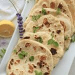 Platter of sourdough flatbread with lemons and herbs