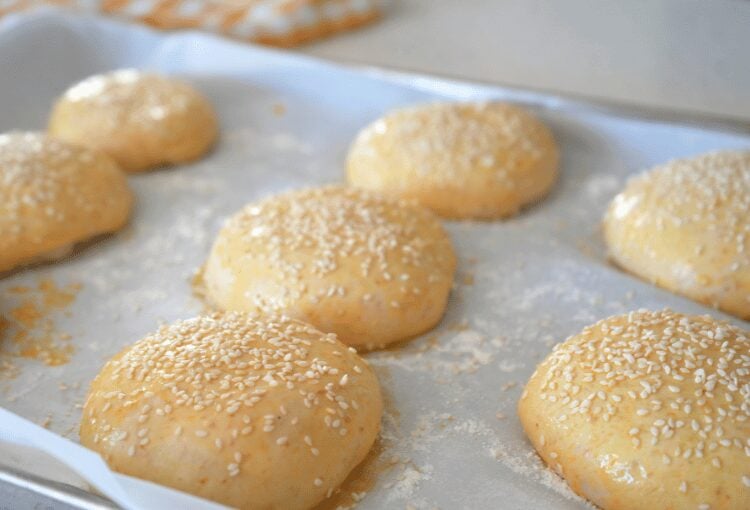 Sesame seeds on unbaked sourdough burger buns