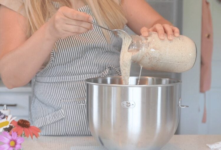Woman pouring starting into mixing bowl