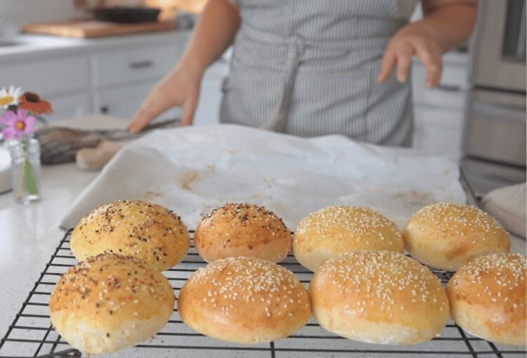 Finished sourdough burger buns on cooling rack