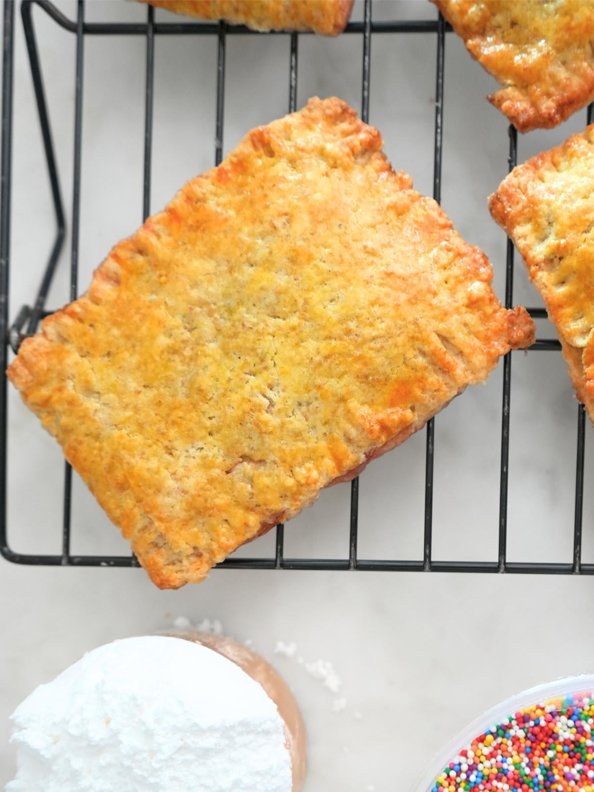 Baked sourdough Pop Tarts on a cooling rack.