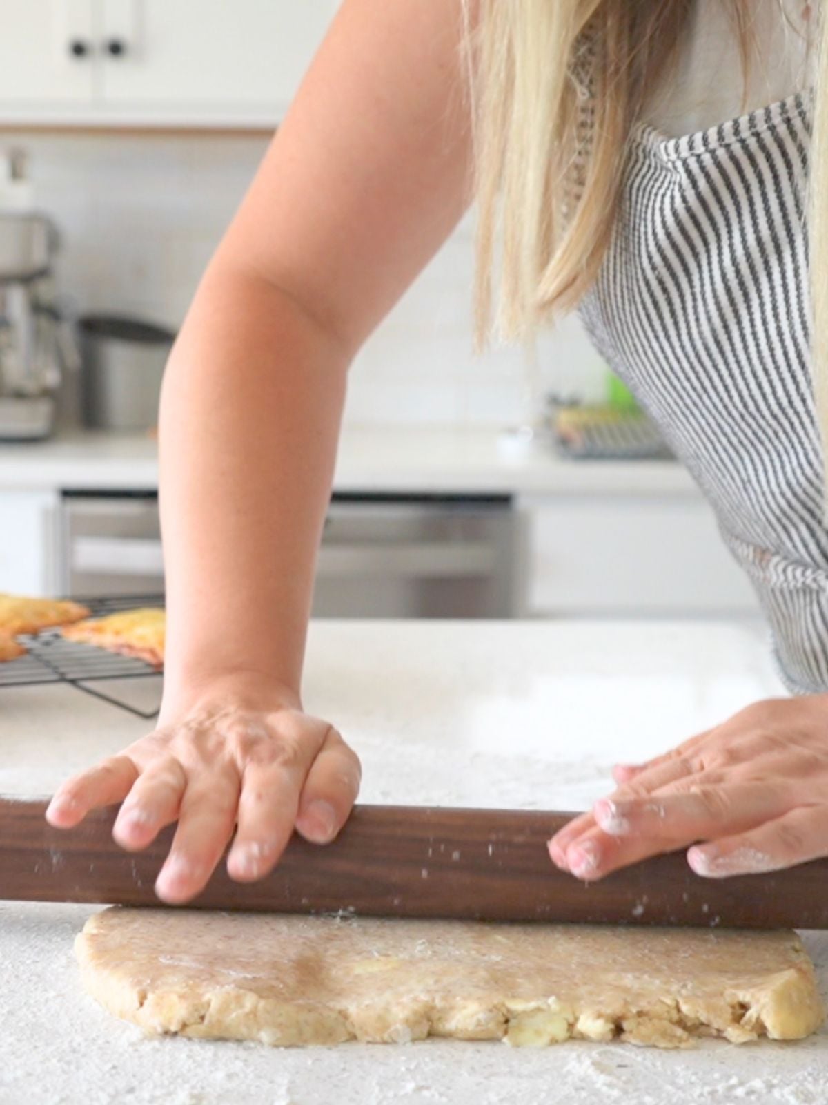 A woman rolling out pie dough.