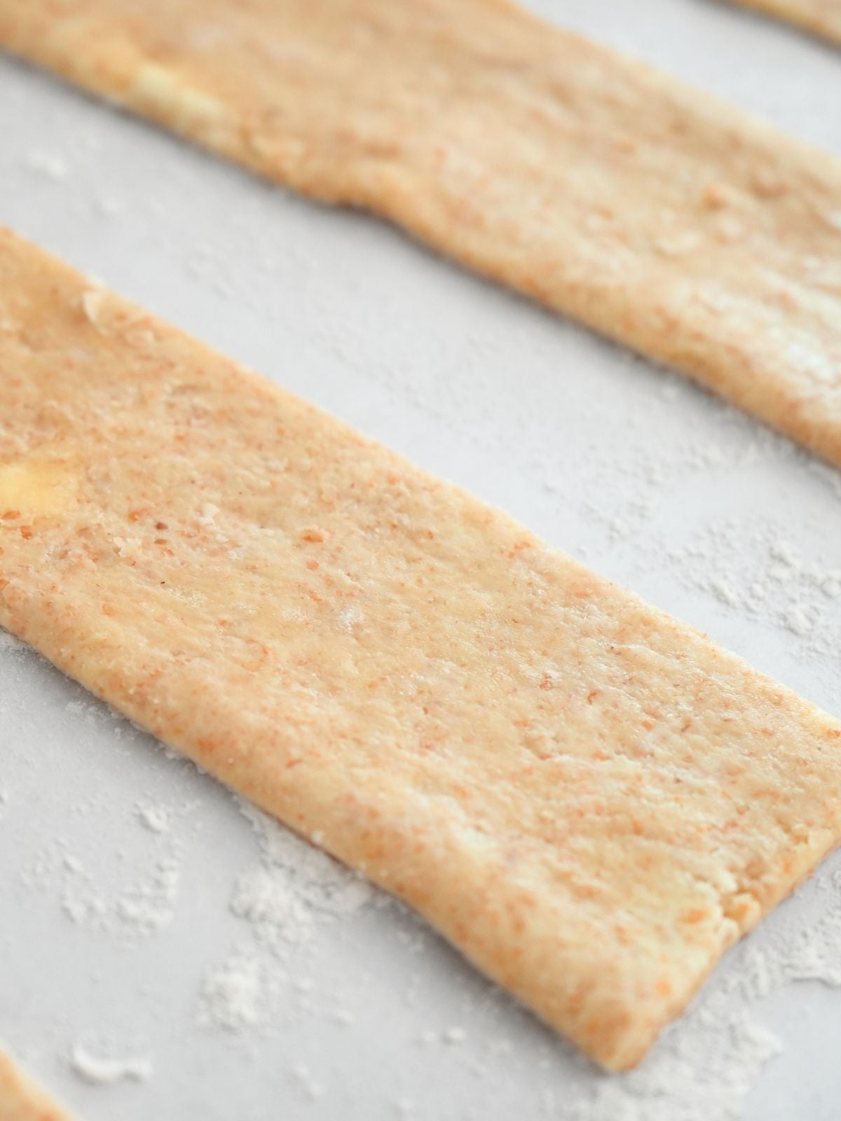 Cut rectangles of sourdough pie dough.