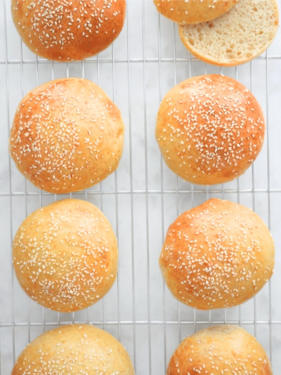Sourdough burger buns on a wire cooling rack