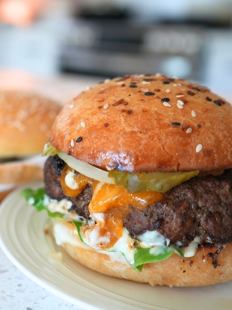 A cheeseburger on a sourdough burger bun