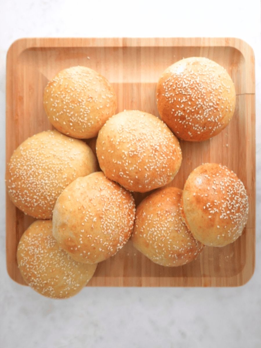 Sourdough burger buns piles on a wooden board