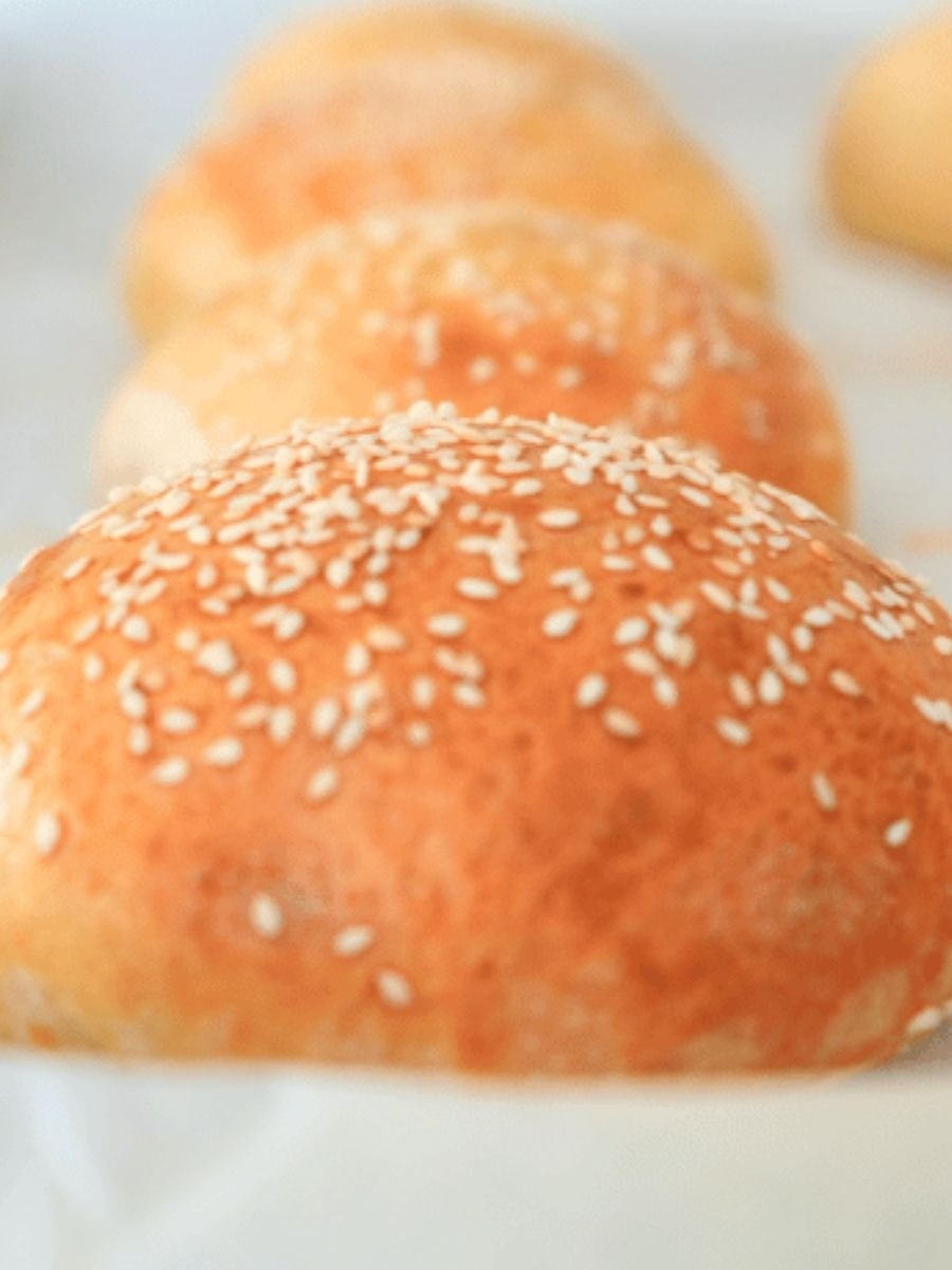 Close up of a sourdough burger bun topped with sesame seeds