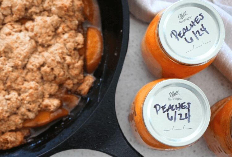Canned peaches next to skillet dessert