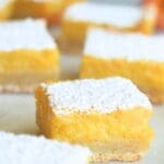 Sourdough lemon bars scattered on a counter.