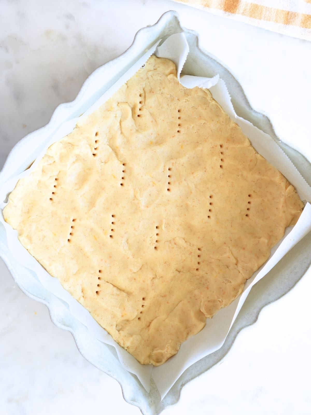 Unbaked crust with holes poked in it.