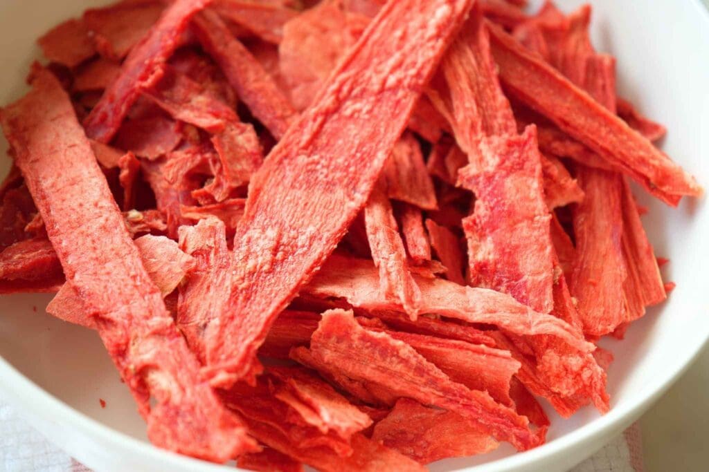 A close up of dehydrated watermelon in a white bowl