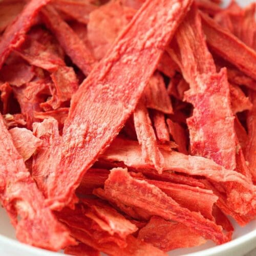 A close up of dehydrated watermelon in a white bowl
