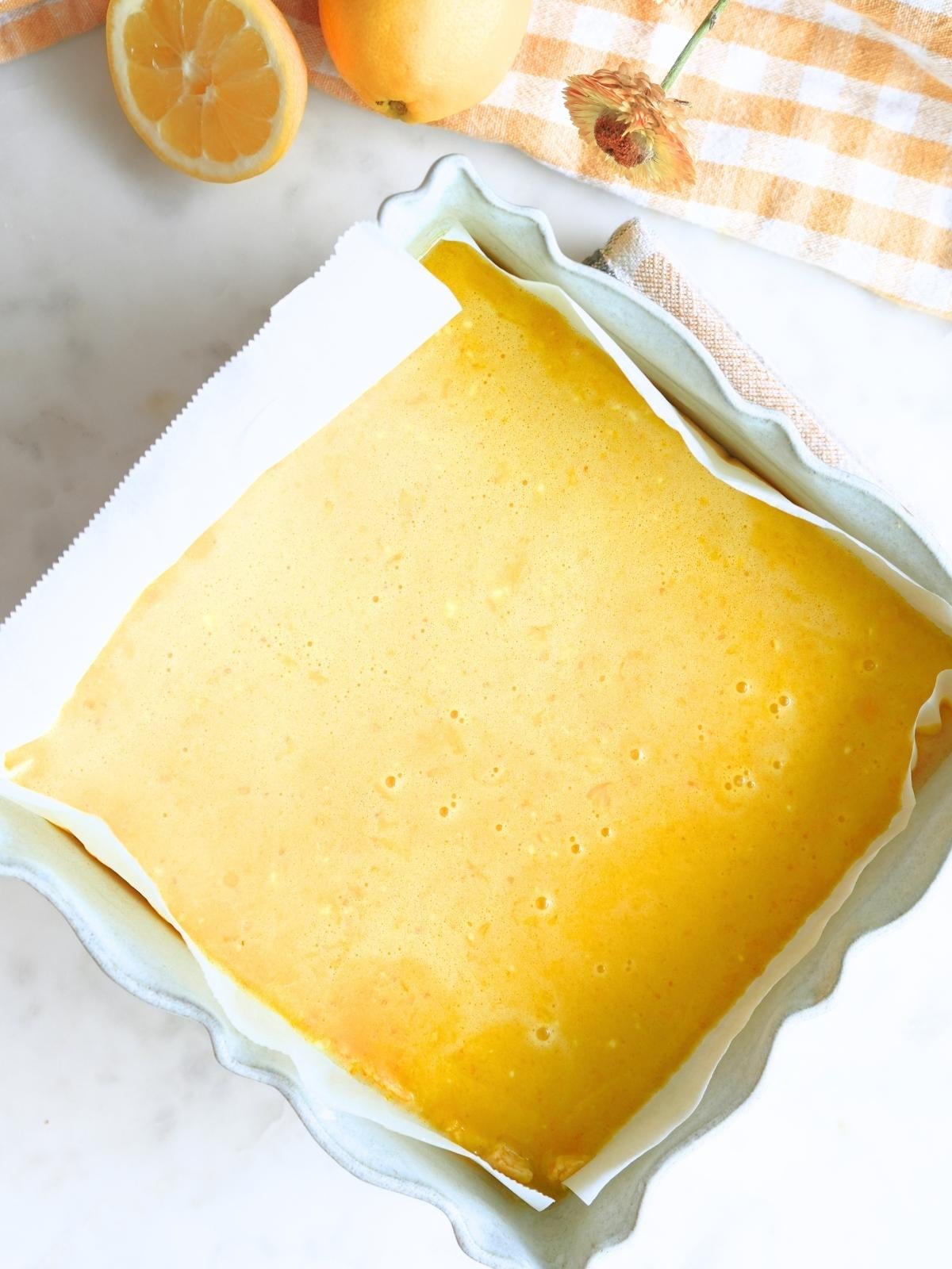 Lemon bar filling in a baking dish, prepared for baking.