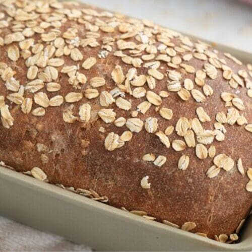 Sourdough maple oatmeal sandwich bread in stone loaf pan