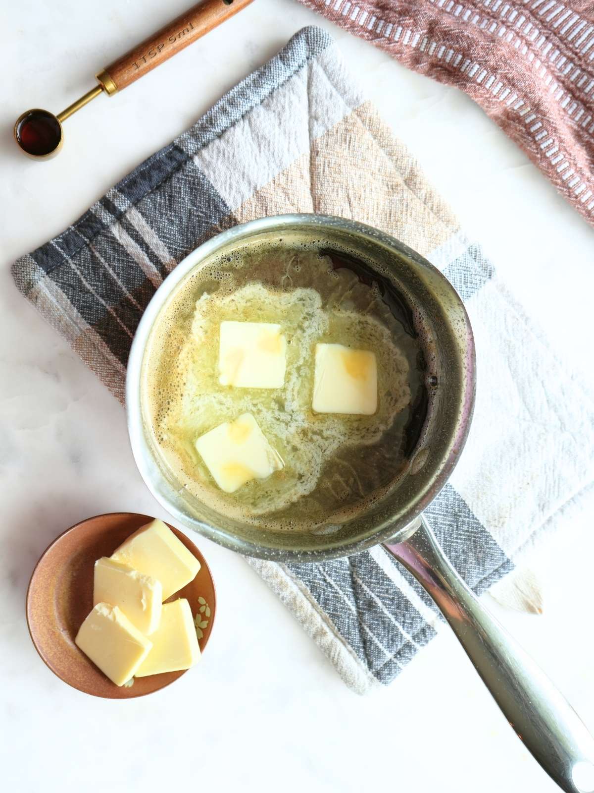 Molasses syrup mixture with melted butter in saucepan.