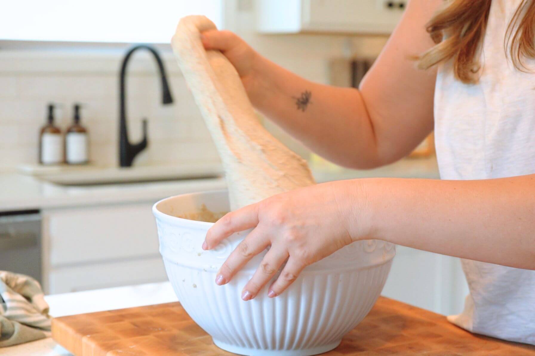 Rebecca stretching sourdough bread dough