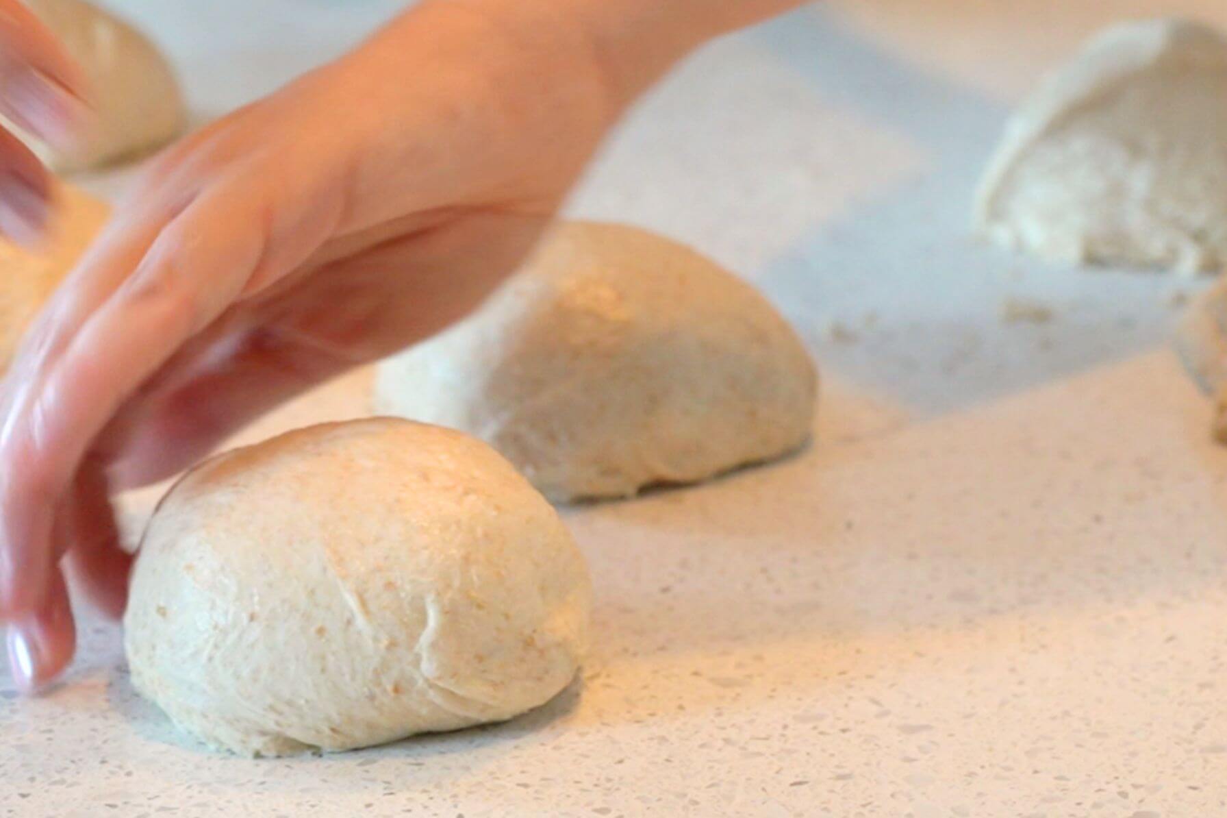 Rebecca shaping dough on countertop