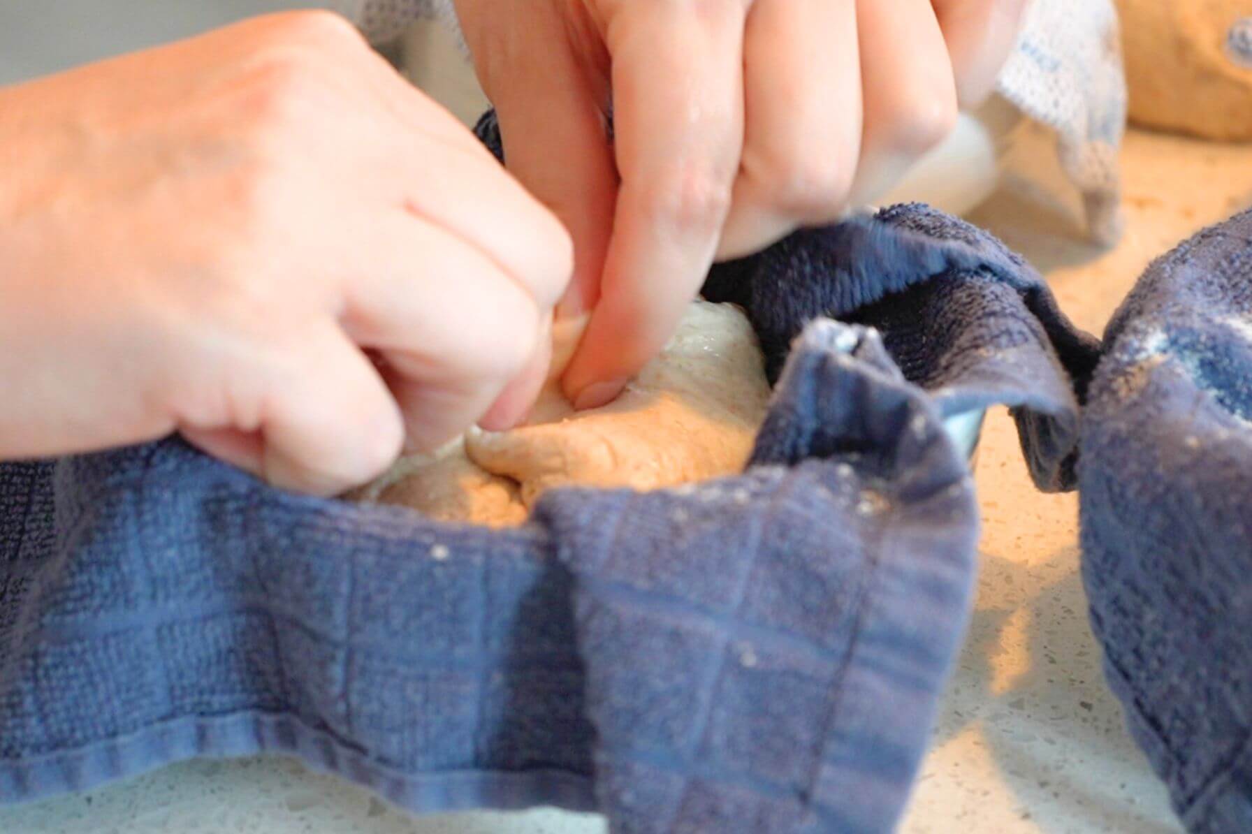 Close up of Rebecca pinching seams of dough together