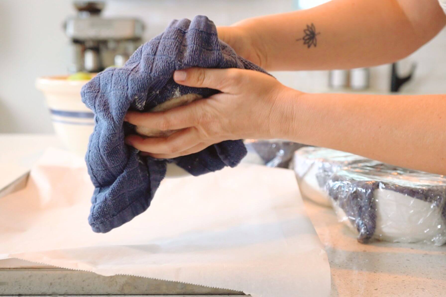 Rebecca turning out dough onto parchment paper lined baking sheet