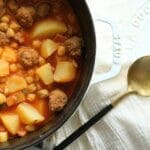Cuban garbanzo recipe with sausage, potatoes, and ham in Staub Dutch oven