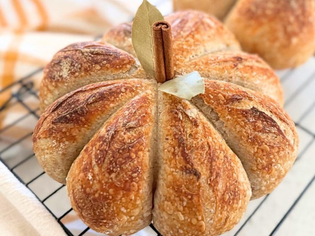 A sourdough pumpkin resting on a wire rack.