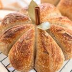 A sourdough pumpkin resting on a wire rack.