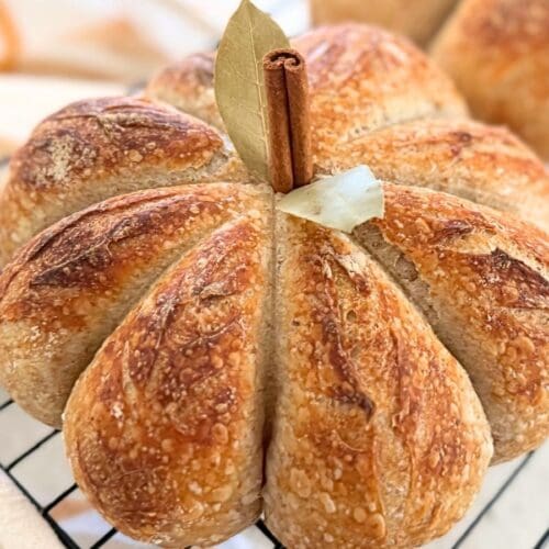 A sourdough pumpkin resting on a wire rack.