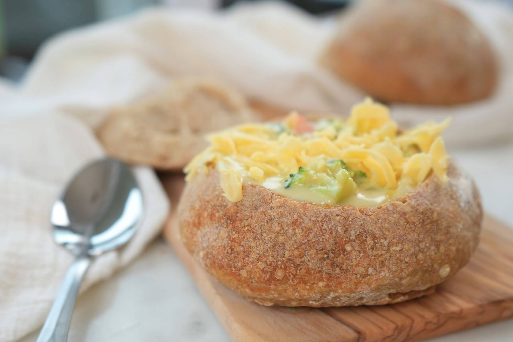 Sourdough bread bowl with cheesy broccoli soup in it