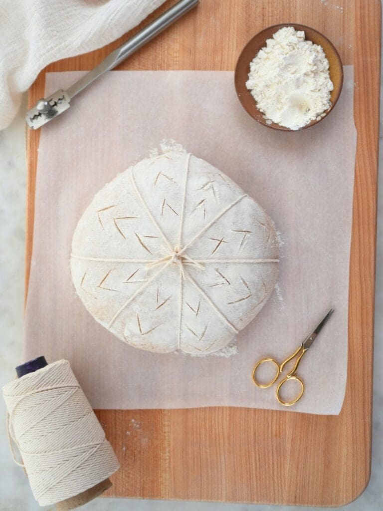 Pumpkin-shaped dough with scoring marks.