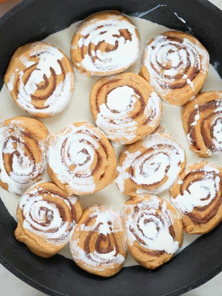 Heavy cream poured over unbaked cinnamon rolls.