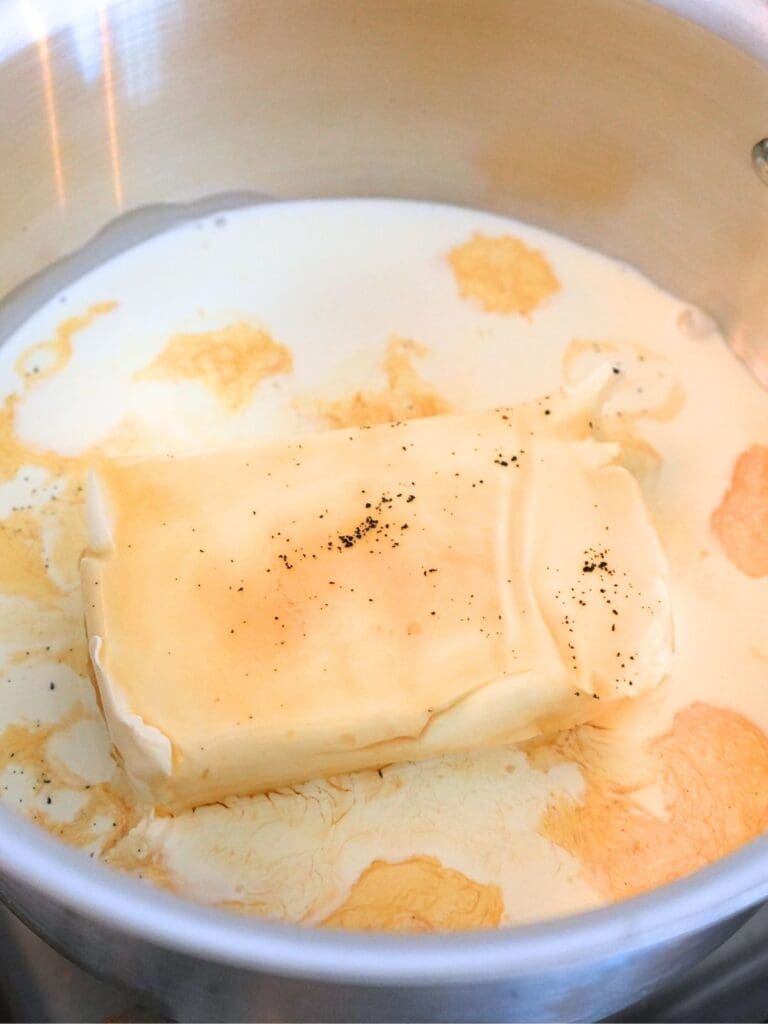 Cinnamon roll frosting ingredients in a pot.