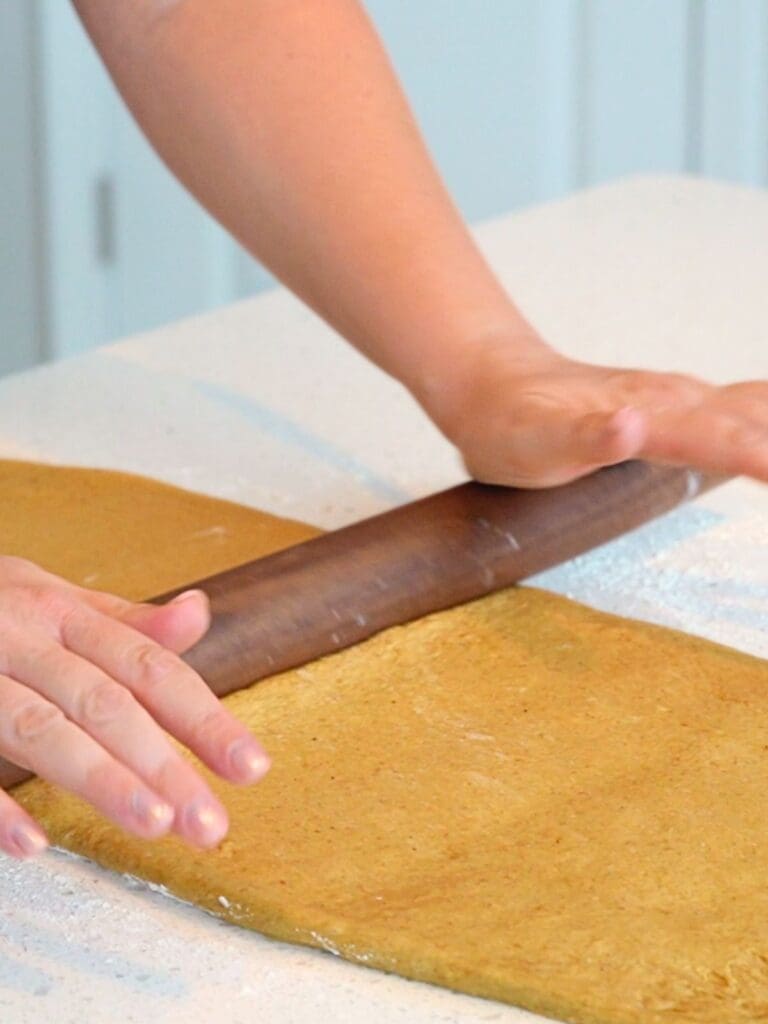 Dough rolled into a rectangle with a rolling pin.