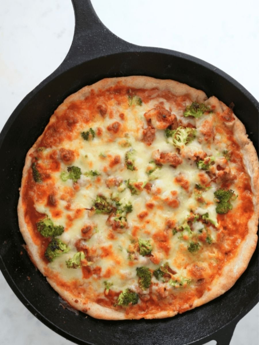 Pizza made with sourdough pizza dough in a cast iron skillet