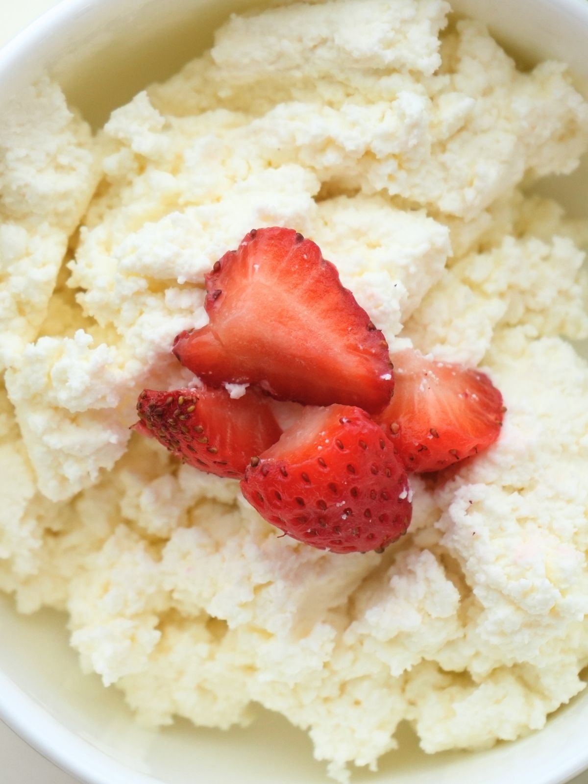 Sliced strawberries on homemade cottage cheese.