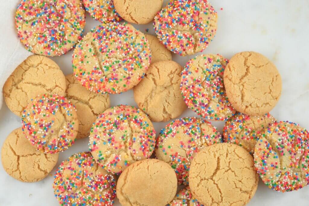 Sugar cookies piled on a table