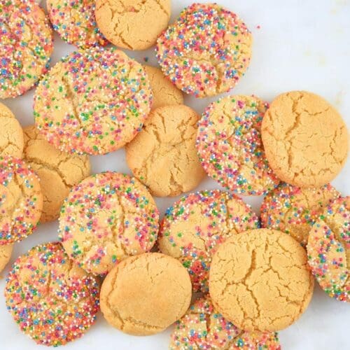 Sugar cookies piled on a counter.