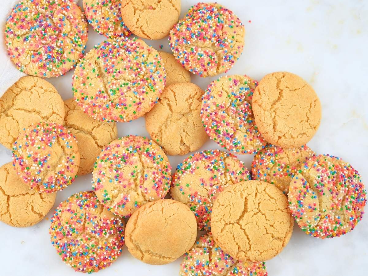 Sugar cookies piled on a counter.