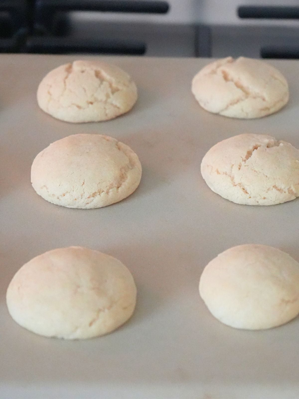 Underbaked cookies on a baking stone in the oven.