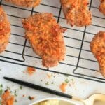 Sourdough crispy cheddar pork chops on a cooling rack, paired with creamy mashed potatoes