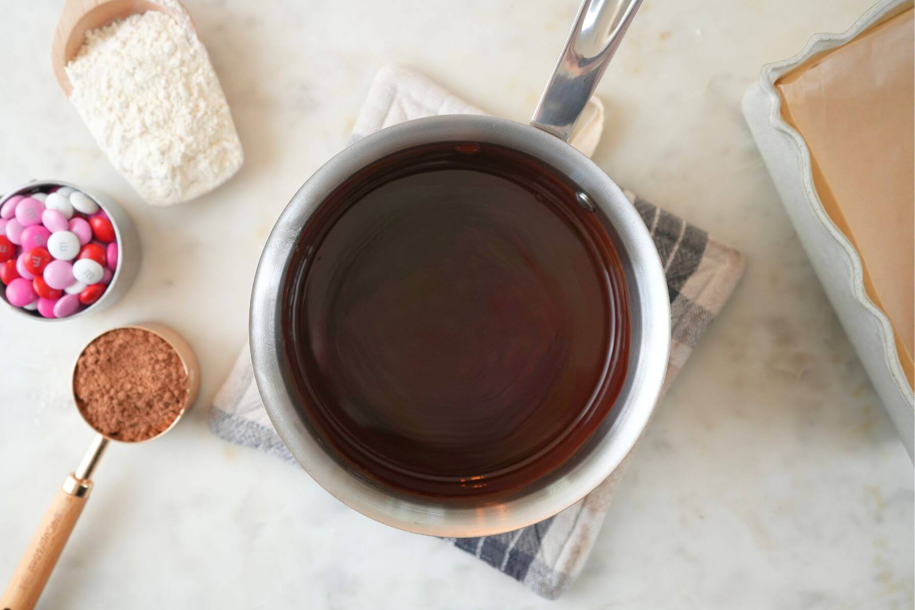 Saucepan filled with melted chocolate and butter.