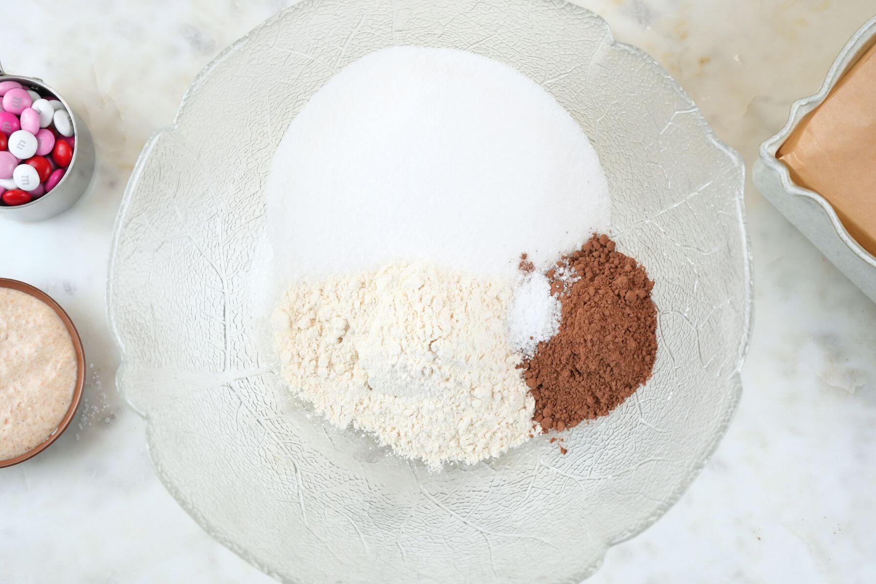 A mixing bowl with flour, sugar, cocoa powder, and salt.